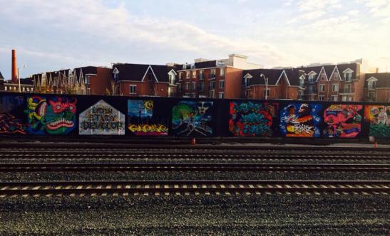 Canada's largest graffiti production wall. This was completed three years ago. It's a seemingly endless wall alongside the tracks in Parkdale - Sudbury Street. This is a small portion, but my favourite part. The sunset doesn't hurt flaw image either. 